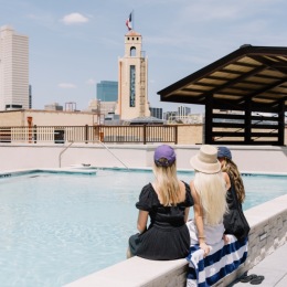 women sitting at the pool