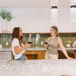residents with wine in kitchen