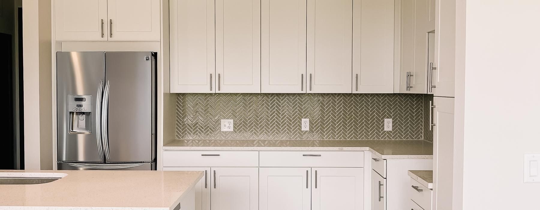 a kitchen with white cabinets